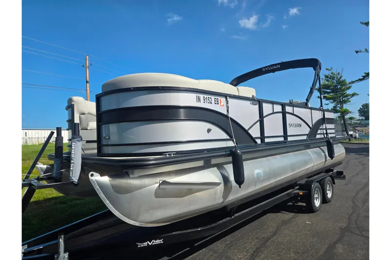 Slide: The Image of 2018 Sylvan Mirage Cruise 8522 LZ LE pontoon boat on trailer, under clear blue sky. - 5