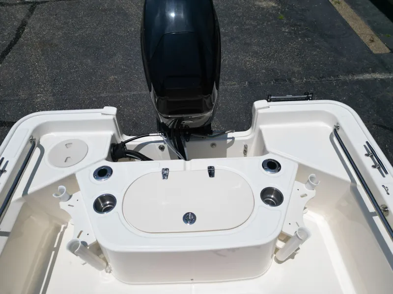 Slide: The Image of The image shows the stern of a 2023 Boston Whaler 150 Montauk boat with an outboard motor. - 21