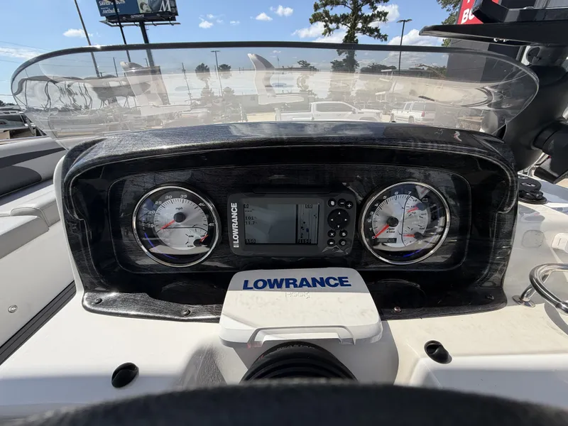 Slide: The Image of The dashboard of a 2018 Hurricane 201 SS with gauges and a Lowrance navigation system. - 16