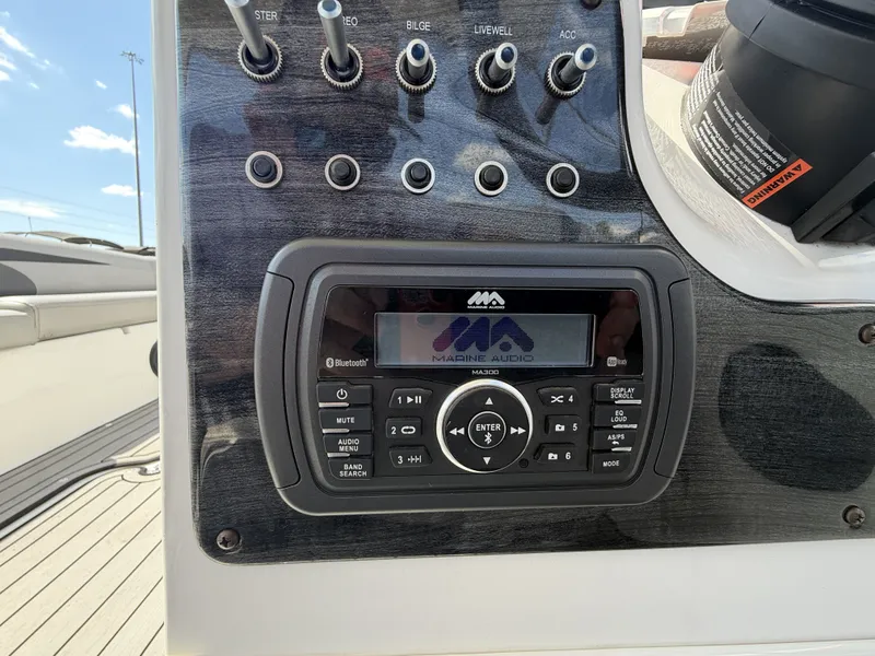 Slide: The Image of The image shows a marine audio system on a boat, surrounded by various switches and controls. - 15