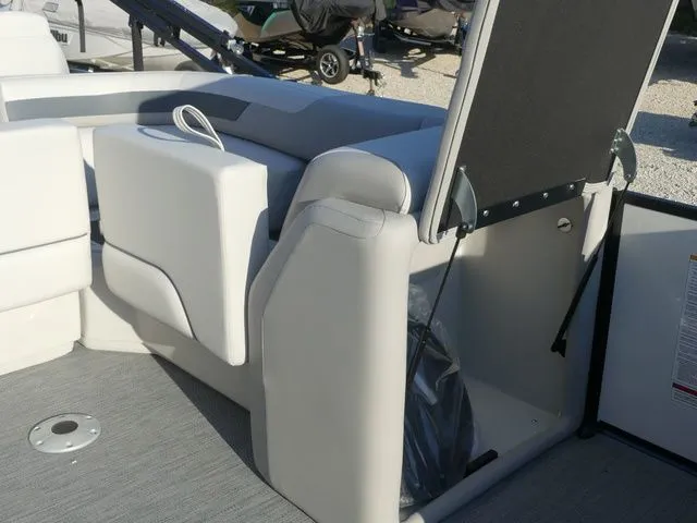 Slide: The Image of The image shows the interior of a 2026 Sweetwater SW 2086 FS boat with gray upholstery. - 39