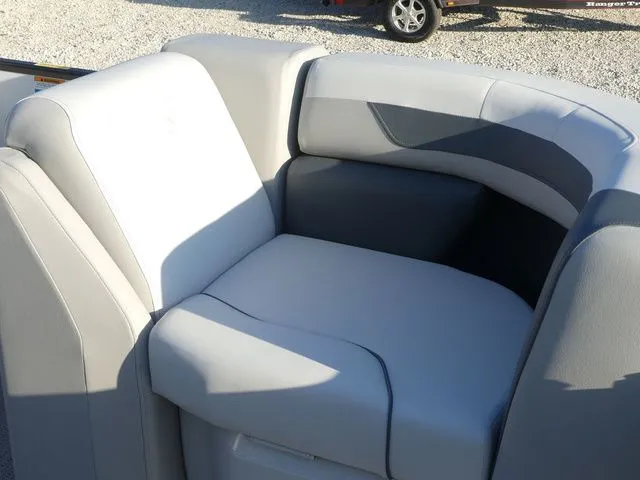 Slide: The Image of A gray upholstered seat on a boat, surrounded by gravel ground. - 19