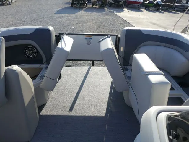 Slide: The Image of The image shows the interior of a 2026 Sweetwater SW 2086 FS boat. It features gray upholstered seats and carpeted flooring. - 36