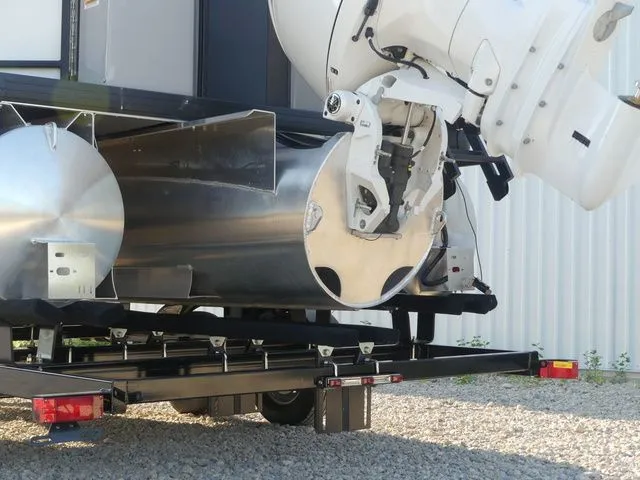Slide: The Image of A Sweetwater SW 2086 FS pontoon boat on a trailer, featuring a large outboard motor. - 9