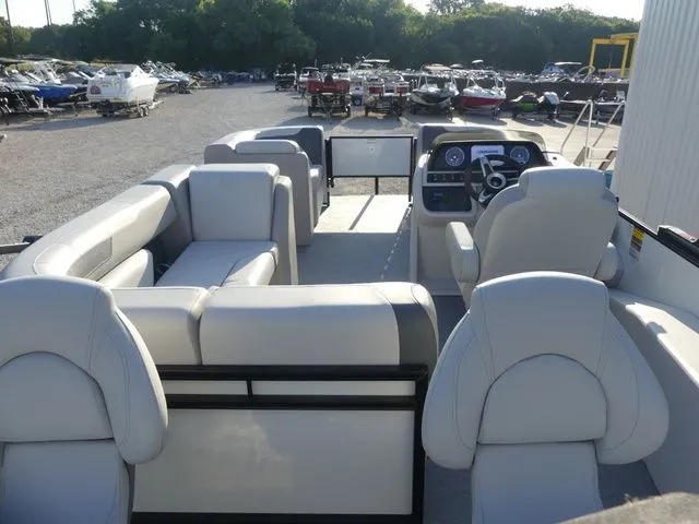 Slide: The Image of The image shows the interior of a 2026 Sweetwater SW 2086 FS boat with gray seating and a helm. - 28