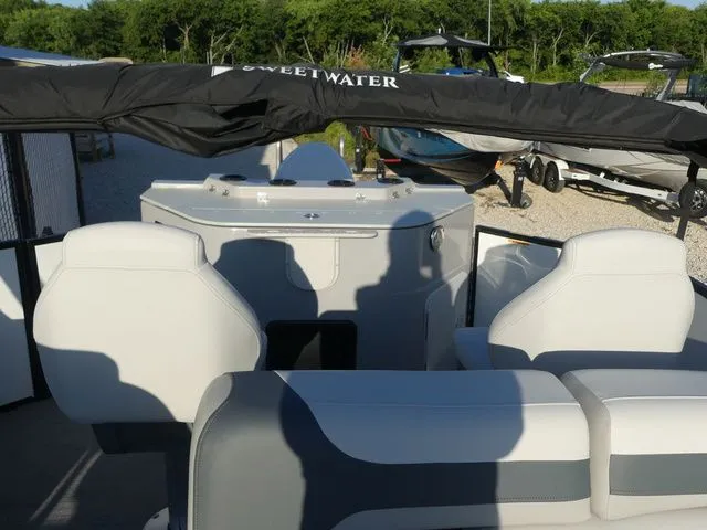 Slide: The Image of The image shows the cockpit of a Sweetwater SW 2086 FS boat with white seats and a black canopy. - 25
