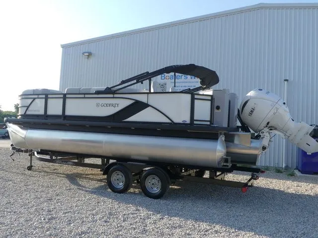 Slide: The Image of A 2026 Sweetwater SW 2086 FS pontoon boat on a trailer in front of a building. - 5