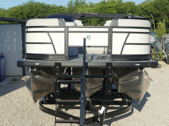 Slide: The Image of A 2026 Sweetwater SW 2086 FS pontoon boat on a trailer in a gravel lot. - 3