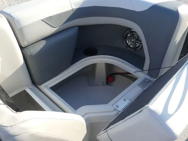 Slide: The Image of The image shows a gray and white boat seat with a speaker and storage space underneath. - 37