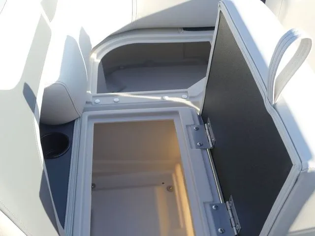 Slide: The Image of The image shows an open storage compartment in a boat with white upholstery and a cup holder. - 41