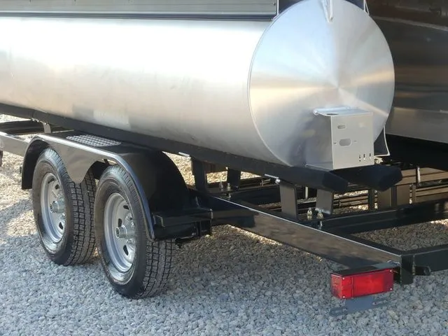 Slide: The Image of A Sweetwater SW 2086 FS pontoon boat on a dual-axle trailer, parked on gravel. - 11