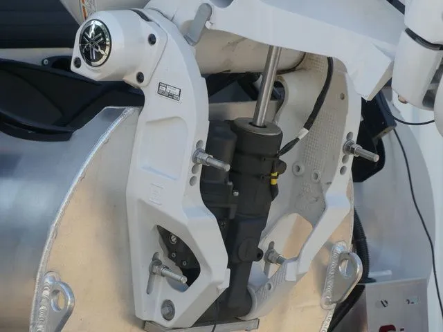 Slide: The Image of Close-up of a boat motor with hydraulic components and metal parts. - 10
