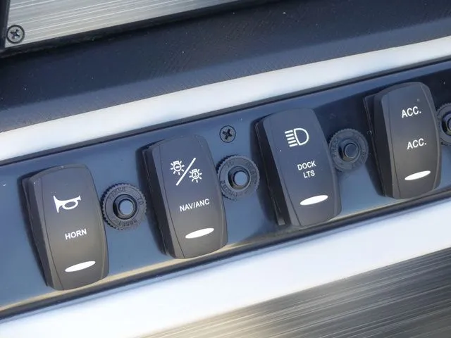 Slide: The Image of Close-up of switches on a boat panel, including horn, navigation lights, and dock lights. - 45