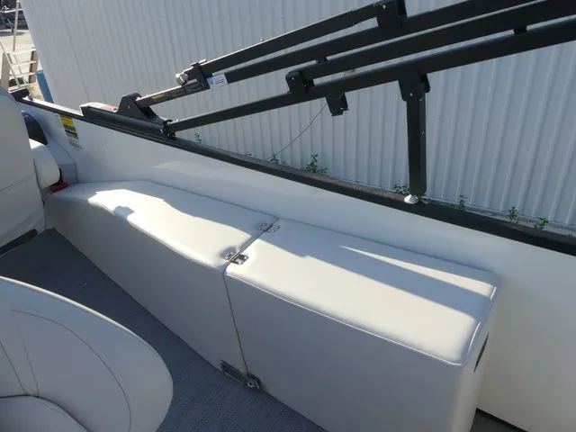 Slide: The Image of The image shows a bench seat on a 2026 Sweetwater SW 2086 FS boat, with a railing above. - 30