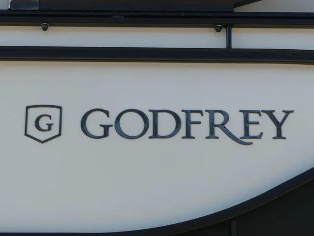 Slide: The Image of Close-up of the Godfrey logo on a Sweetwater SW 2086 FS boat. - 15
