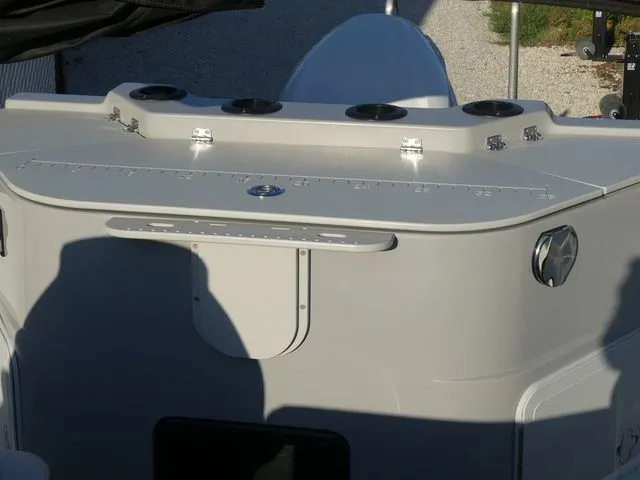 Slide: The Image of The image shows the stern of a Sweetwater SW 2086 FS boat with rod holders and storage. - 26