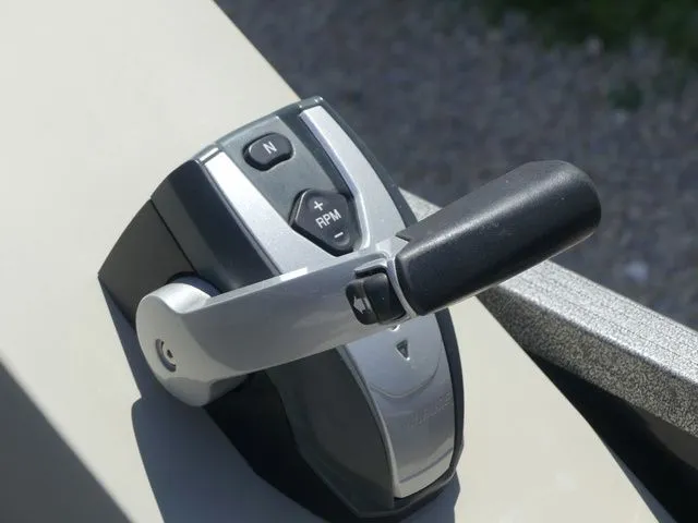 Slide: The Image of Close-up of a throttle lever on a boat, featuring buttons for neutral and RPM. - 40