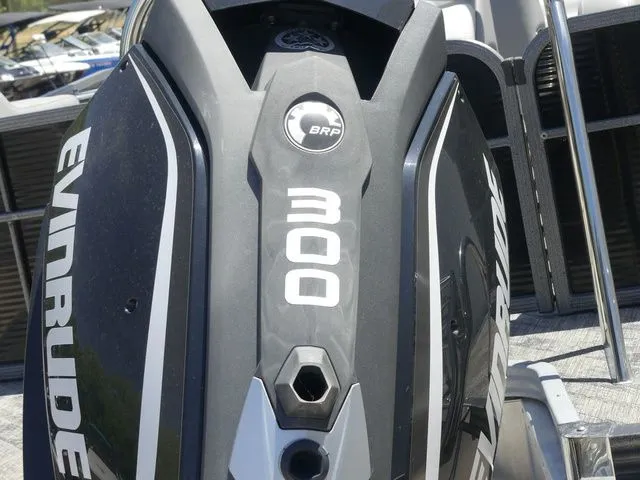 Slide: The Image of Close-up of an Evinrude 300 outboard motor on a Manitou Encore 25 SR SHP boat. - 23