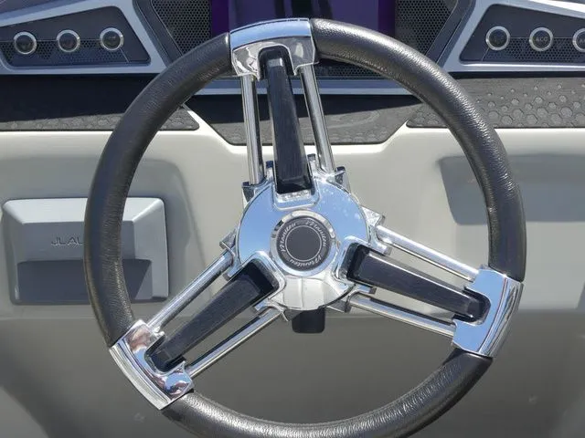 Slide: The Image of Close-up of a stylish steering wheel with chrome accents on a boat. - 37