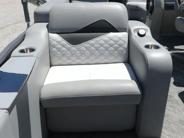 Slide: The Image of A gray and white seat with quilted pattern and cup holders on a boat. - 44