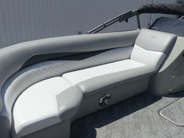 Slide: The Image of The image shows a gray and white seating area on a boat with sleek upholstery. - 18