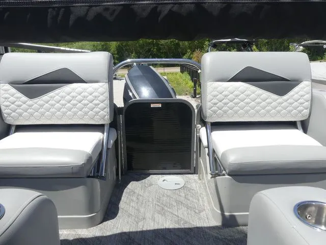 Slide: The Image of The image shows the interior of a 2019 Manitou Encore 25 SR SHP with sleek, upholstered seating. - 34