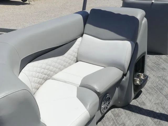 Slide: The Image of Gray and white upholstery on a boat seat with cup holders and speaker. - 26