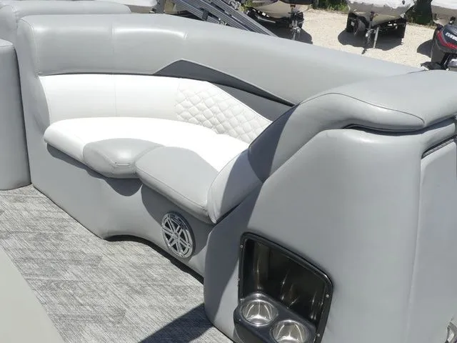 Slide: The Image of The image shows a luxurious gray seating area on a boat with cushioned seats and cup holders. - 20
