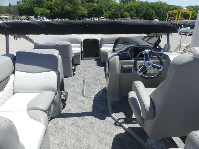 Slide: The Image of The image shows the cockpit of a 2019 Manitou Encore 25 SR SHP with gray seating and a steering wheel. - 25