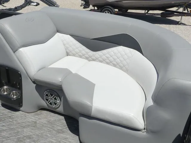 Slide: The Image of Gray and white cushioned seating with speaker and cup holders on a boat. - 17