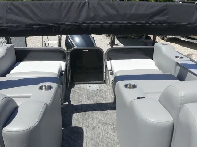 Slide: The Image of The image shows the interior of a 2019 Manitou Encore 25 SR SHP with gray seating. - 22