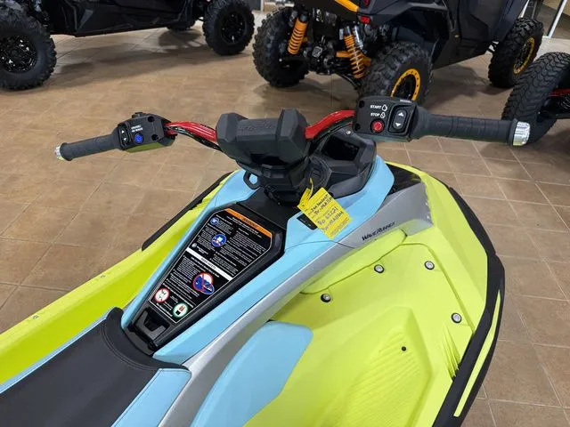 Slide: The Image of A 2025 Yamaha WaveRunner JetBlaster with bright yellow and blue bodywork, displayed on a floor. - 3