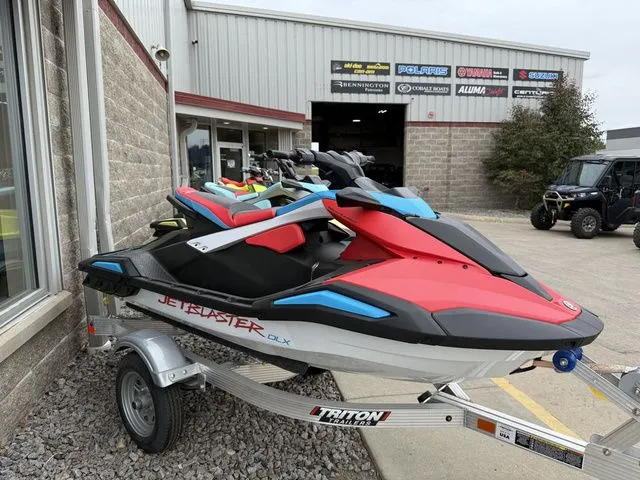 The Image of A 2025 Yamaha WaveRunner JetBlaster DLX 3-Up on a trailer outside a building. - 1