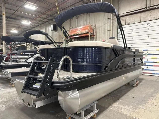 Slide: The Image of A 2026 Bennington S Quad Bench 23 SSR pontoon boat in a warehouse setting. - 8