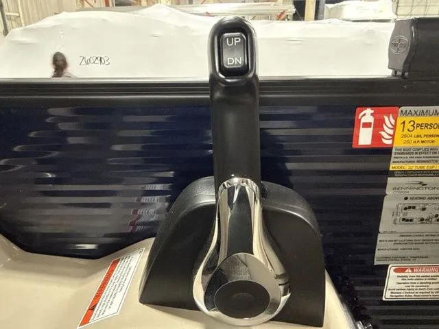 Slide: The Image of Close-up of a boat lever with up and down buttons, surrounded by safety stickers. - 14