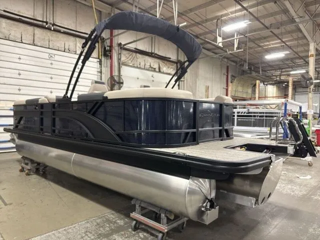 Slide: The Image of A Bennington pontoon boat, model S Quad Bench 23 SSR, is in a warehouse. - 6