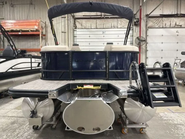Slide: The Image of The image shows a Bennington pontoon boat, model S Quad Bench 23 SSR, year 2026, in a warehouse. - 7