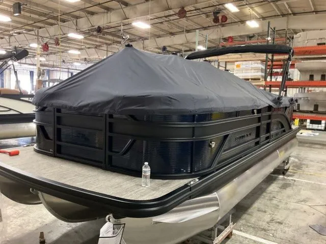 Slide: The Image of A Bennington pontoon boat, model S Quad Bench 23 SSR, year 2026, is in a warehouse. - 18