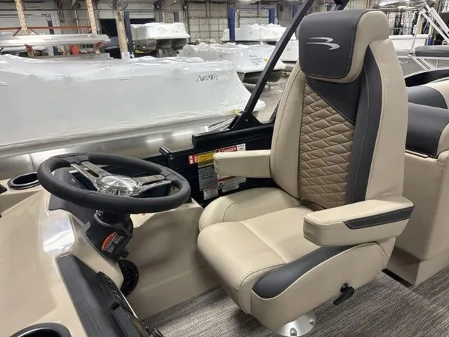 Slide: The Image of The image shows the helm of a 2026 Bennington S Quad Bench 23 SSR with a cushioned captain's chair. - 12
