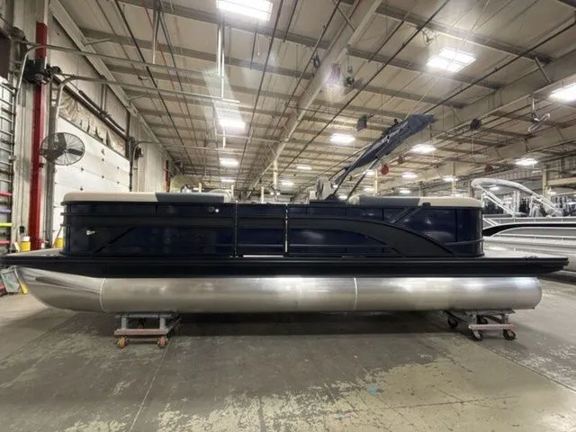 Slide: The Image of A Bennington pontoon boat, model S Quad Bench 23 SSR, is in a warehouse. - 5
