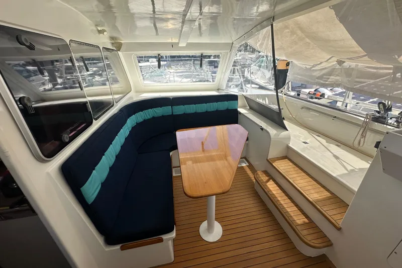 Slide: The Image of Interior of 1999 Baltec Engineering Visiona Catamaran with seating and wooden table. - 18