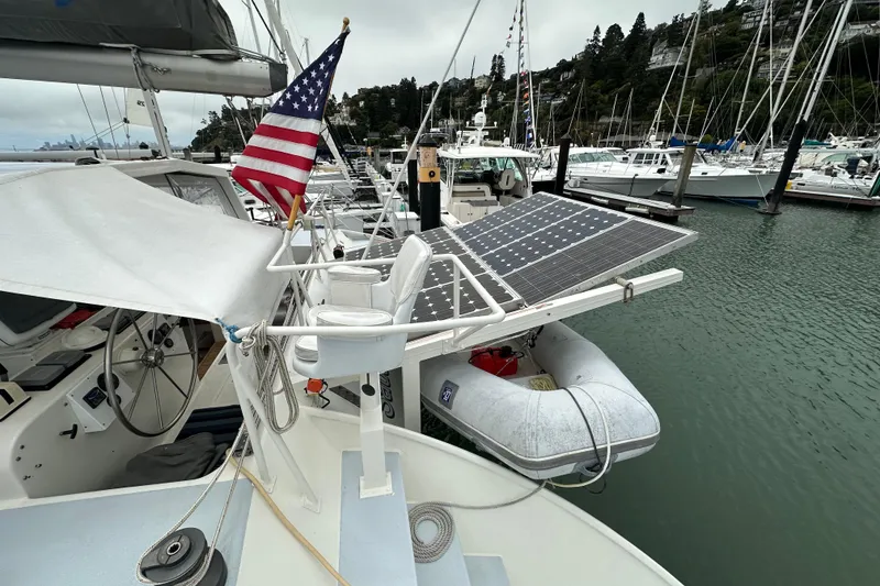 Slide: The Image of Baltec Engineering Visiona Catamaran 1999 with solar panels and American flag in marina. - 15