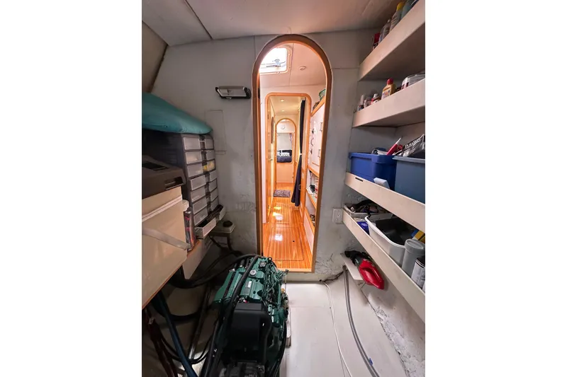Slide: The Image of Interior of 1999 Baltec Engineering Visiona Catamaran with engine and storage shelves. - 56