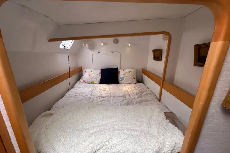 Slide: The Image of Cozy cabin interior of 1999 Baltec Engineering Visiona Catamaran with bed and wooden accents. - 37