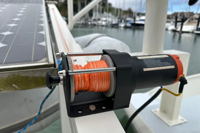 Slide: The Image of Electric winch on Baltec Engineering Visiona Catamaran, 1999, with solar panel in marina background. - 11
