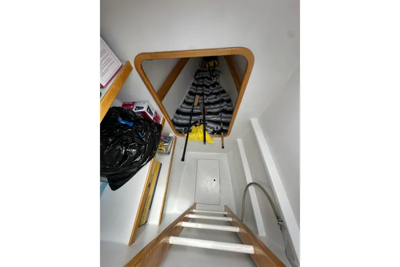 Slide: The Image of Interior storage area of a 1999 Baltec Engineering Visiona Catamaran with ladder and shelves. - 38