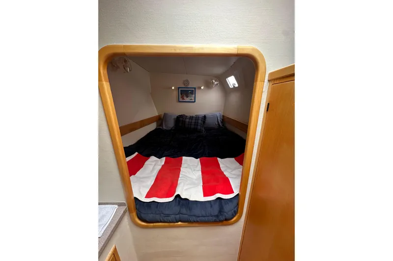 Slide: The Image of Cozy cabin interior of 1999 Baltec Engineering Visiona Catamaran with striped bedding. - 34