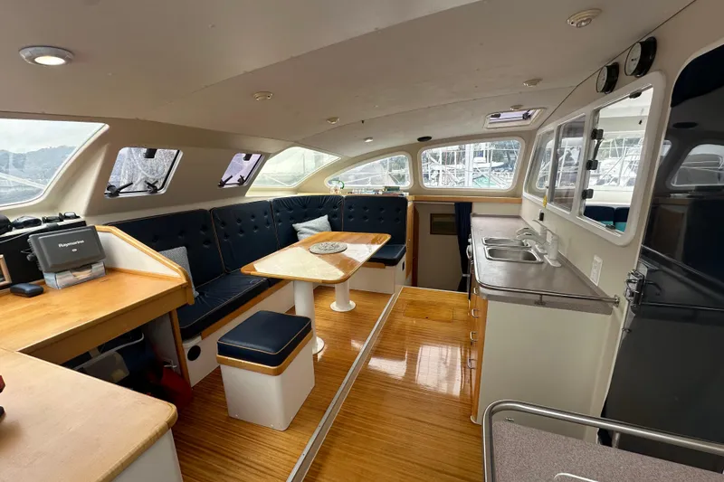 Slide: The Image of Interior of 1999 Baltec Engineering Visiona Catamaran with modern seating and kitchen area. - 22