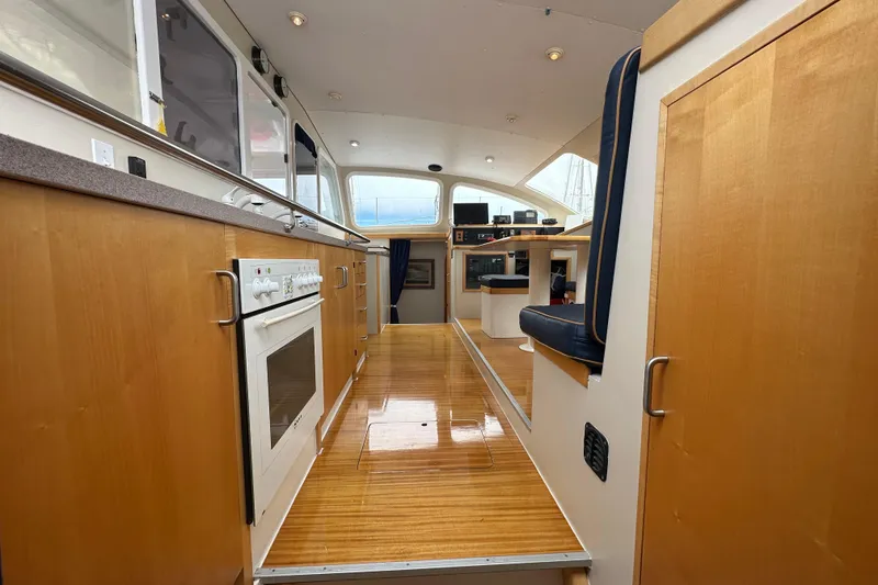 Slide: The Image of Interior of 1999 Baltec Engineering Visiona Catamaran with modern kitchen and seating area. - 27
