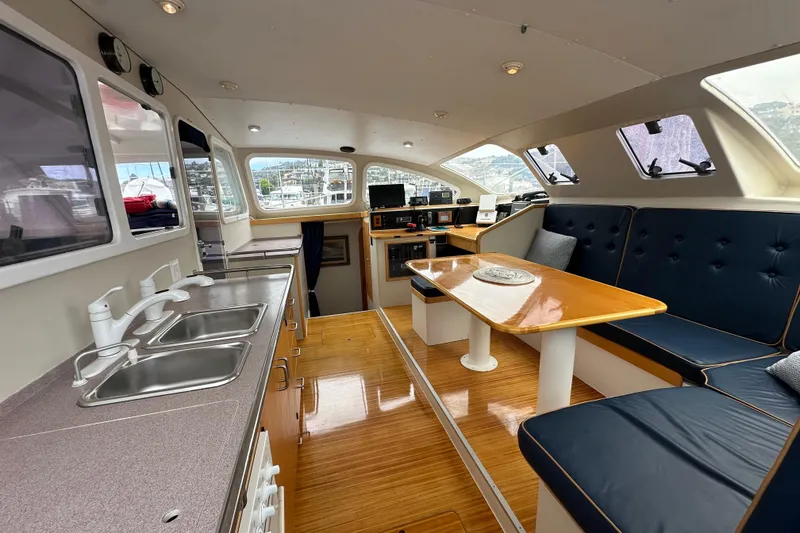 Slide: The Image of Interior of 1999 Baltec Engineering Visiona Catamaran with kitchen and seating area. - 21